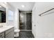 Modern bathroom showcasing black tile floors, a glass shower and neutral color palette at 5010 Arbordale Way # 5, Mount Holly, NC 28120