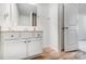 Bathroom with white vanity, brushed metal hardware, wood-look flooring, and access to a tiled shower at 5010 Arbordale Way # 5, Mount Holly, NC 28120