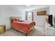 Cozy bedroom featuring neutral carpet, a window with privacy blinds, and a comfortable bed at 5010 Arbordale Way # 5, Mount Holly, NC 28120
