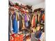 Messy walk-in closet features ample hanging space, shelving for shoes, and storage for wardrobe at 5010 Arbordale Way # 5, Mount Holly, NC 28120