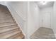 Bright entryway featuring neutral walls, luxury vinyl plank floors, and a staircase to the upper level at 5010 Arbordale Way # 5, Mount Holly, NC 28120