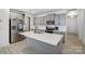 Modern kitchen featuring stainless appliances, gray cabinets, white countertops, a center island and wood-look flooring at 5010 Arbordale Way # 5, Mount Holly, NC 28120