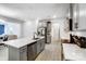 Open kitchen featuring an island, modern appliances, gray cabinets and views of the connected living area at 5010 Arbordale Way # 5, Mount Holly, NC 28120
