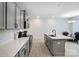 Modern kitchen featuring stainless appliances, gray cabinets, white countertops, and views of the connected dining area at 5010 Arbordale Way # 5, Mount Holly, NC 28120