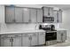 Modern kitchen featuring gray cabinets, white countertops, stainless steel appliances and a white subway tile backsplash at 5010 Arbordale Way # 5, Mount Holly, NC 28120