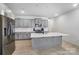 Modern kitchen featuring stainless appliances, gray cabinets, white countertops, a center island and wood-look flooring at 5010 Arbordale Way # 5, Mount Holly, NC 28120