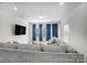 Comfortable living room with a large sofa, TV, recessed lights, and bright windows with blue drapes at 5010 Arbordale Way # 5, Mount Holly, NC 28120