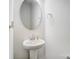 Simple, clean powder room with pedestal sink, round mirror, and modern fixtures at 5010 Arbordale Way # 5, Mount Holly, NC 28120