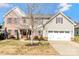 Charming two-story home boasts a brick facade, two-car garage, and a well-manicured front yard at 5020 Clover Hill Rd # 61, Indian Trail, NC 28079