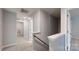 Well-lit hallway featuring carpet, neutral paint, and white trim at 7128 Pennyroyal Way, Charlotte, NC 28216