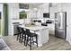 Lovely white kitchen features stainless appliances, center island and breakfast bar at 7200 Hodges Meadow Ln, Charlotte, NC 28213