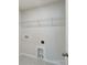 Functional laundry room with wire shelving, utility connections, and a minimalist design for easy organization at 7200 Hodges Meadow Ln, Charlotte, NC 28213