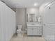 Clean bathroom with a vanity, tiled floor, and bright lighting at 721 Governor Morrison St # 408, Charlotte, NC 28211