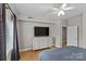 Bright bedroom with a large dresser, TV, and hardwood floors, creating a comfortable space at 721 Governor Morrison St # 408, Charlotte, NC 28211