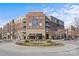 Elegant condominium building featuring brick and beige siding with beautiful landscaping and a roundabout at 721 Governor Morrison St # 408, Charlotte, NC 28211