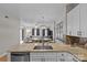 Open-concept kitchen featuring a kitchen island with sink, bar seating, stainless appliances, and views of living area at 721 Governor Morrison St # 408, Charlotte, NC 28211