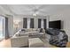 Spacious living room with hardwood floors, plush sectional, large TV, and abundant natural light at 721 Governor Morrison St # 408, Charlotte, NC 28211