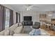 Spacious living room featuring a modern entertainment center, sofa, and a dining area at 721 Governor Morrison St # 408, Charlotte, NC 28211