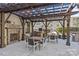 Community outdoor grilling area with stone fireplace and wood pergola, perfect for entertaining guests at 721 Governor Morrison St # 408, Charlotte, NC 28211