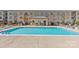 Outdoor pool area with lounge chairs and well-maintained landscaping, perfect for relaxation and recreation at 721 Governor Morrison St # 408, Charlotte, NC 28211