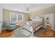 Sunlit bedroom features hardwood floors, large window, and an accent chair at 7916 Wellston Dr, Charlotte, NC 28210