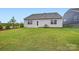 View of backyard with grass and exterior of home with gray siding and white trim at 8418 Norman Forest Rd, Lancaster, SC 29720