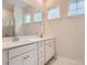 Bathroom with double sink vanity, white cabinets, and a large mirror at 8418 Norman Forest Rd, Lancaster, SC 29720