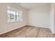 An empty bedroom features wood-look flooring, a neutral wall color and a window at 8418 Norman Forest Rd, Lancaster, SC 29720