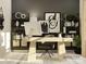 Modern home office space featuring a minimalist desk setup, stylish decor and ample shelving for organization at 8418 Norman Forest Rd, Lancaster, SC 29720