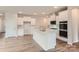 Bright open kitchen featuring white cabinets, a large island, stainless appliances, and modern finishes at 8418 Norman Forest Rd, Lancaster, SC 29720