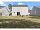 View of the home's rear exterior showcasing a spacious backyard with a sliding door entrance at 10337 Hugue Way, Charlotte, NC 28214