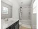 Bright bathroom with a shower and tub combo and a large vanity at 10337 Hugue Way, Charlotte, NC 28214