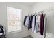 A closet with clothes and a window for natural light at 10337 Hugue Way, Charlotte, NC 28214