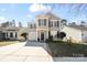 Charming two-story home featuring a classic design, well-maintained landscaping, and attached one car garage at 10337 Hugue Way, Charlotte, NC 28214