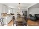 Modern kitchen with white cabinets, stainless steel appliances, and an eat-in dining area at 10337 Hugue Way, Charlotte, NC 28214