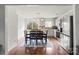 Eat-in kitchen featuring stainless steel appliances, white cabinets, and a sliding glass door to the backyard at 10337 Hugue Way, Charlotte, NC 28214