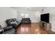 Open-concept living room offers natural light and hardwood floors at 10337 Hugue Way, Charlotte, NC 28214