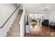 Living room with hardwood floors leading to the stairway and kitchen at 10337 Hugue Way, Charlotte, NC 28214