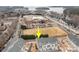 Community aerial view showcases proximity to lake and commercial area with ample parking, highlighting its convenient location at 1037 Naples Dr, Davidson, NC 28036