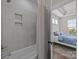 Marble tiled shower with inset shelving attached to a bedroom with tray ceilings at 1037 Naples Dr, Davidson, NC 28036