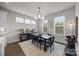 Bright dining room with a modern chandelier, table setting, and beautiful hardwood floors at 1037 Naples Dr, Davidson, NC 28036