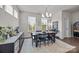 Elegant dining room with modern chandelier, ample natural light and a serving buffet at 1037 Naples Dr, Davidson, NC 28036