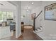 Bright foyer features hardwood floors, stairs, and access to the home office at 1037 Naples Dr, Davidson, NC 28036