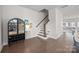 Spacious entryway with hardwood floors, staircase, and built-in bar cabinet at 1037 Naples Dr, Davidson, NC 28036