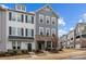 Beautiful townhouse showcasing neutral siding, elegant shutters, and a neatly landscaped lawn and welcoming front door at 1037 Naples Dr, Davidson, NC 28036