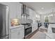 Stylish kitchen showcasing stainless appliances, quartz counters, subway tile backsplash and seamless dining room views at 1037 Naples Dr, Davidson, NC 28036