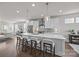 Spacious kitchen featuring an island with bar stools, stainless appliances, and views to living area at 1037 Naples Dr, Davidson, NC 28036