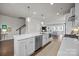 Bright open kitchen featuring an island with stainless steel appliances, and a seamless view of the living room at 1037 Naples Dr, Davidson, NC 28036