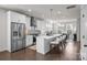 Modern kitchen featuring white cabinetry, stainless steel appliances, and a large center island with bar seating at 1037 Naples Dr, Davidson, NC 28036