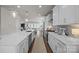 Bright open kitchen with stainless steel appliances, modern white cabinetry and long center island at 1037 Naples Dr, Davidson, NC 28036